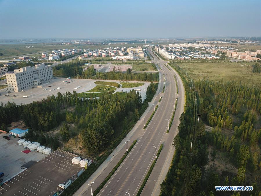 Aerial photo taken on July 31, 2018 shows the view of Duguitala Town in Erdos, north China\'s Inner Mongolia Autonomous Region. Kubuqi, the seventh largest desert in China, is a good example of China\'s success in alleviating desertification. About 6,460 square kilometers of the Kubuqi desert has been reclaimed in the last 30 years. (Xinhua/Xing Guangli)