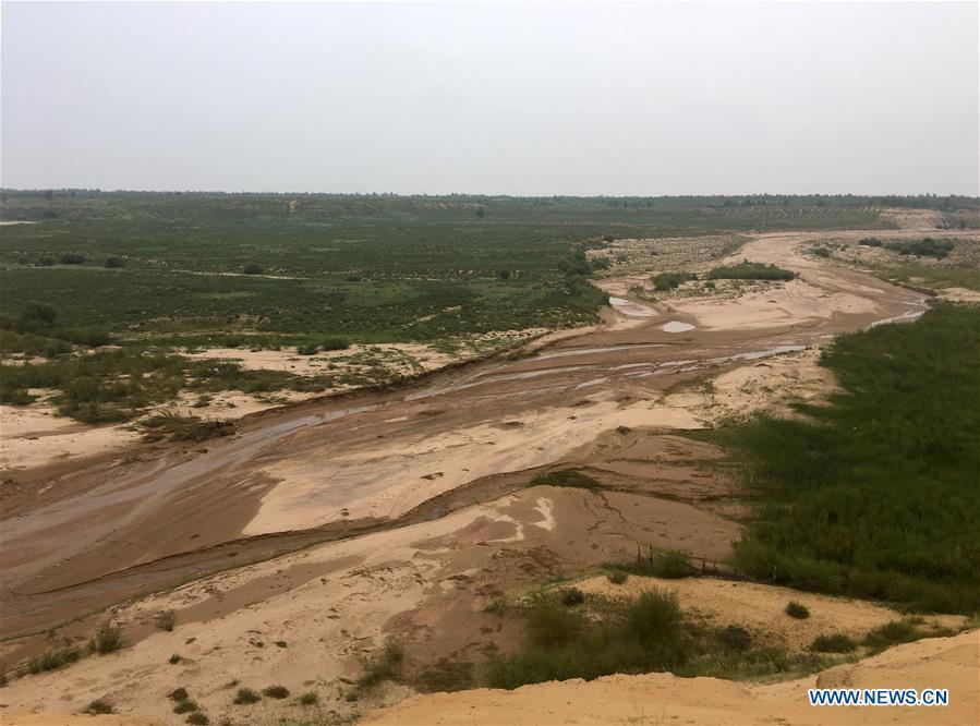 Photo taken on Aug. 1, 2018 shows a seasonal river channel at the Kubuqi Desert in Erdos, north China\'s Inner Mongolia Autonomous Region. Kubuqi, the seventh largest desert in China, is a good example of China\'s success in alleviating desertification. About 6,460 square kilometers of the Kubuqi desert has been reclaimed in the last 30 years. (Xinhua/Zhang Shanchen)