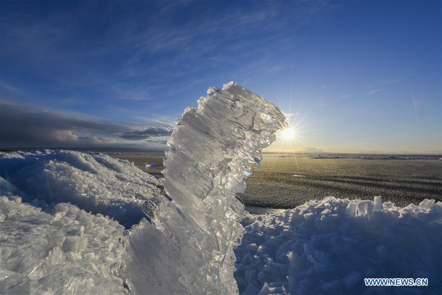 Photo taken on April 3, 2018 shows ice formed in the wind around Ulunggur Lake in Fuhai County, northwest China\'s Xinjiang Uygur Autonomous Region. China\'s westernmost Xinjiang Uygur Autonomous Region welcomed a record high of 107 million tourists in 2017, up 32.4 percent year on year. In addition, tourists spent over 182 billion yuan (28.4 billion U.S. dollars) in Xinjiang last year, 30 percent more than in 2016. (Xinhua/Hu Huhu)
