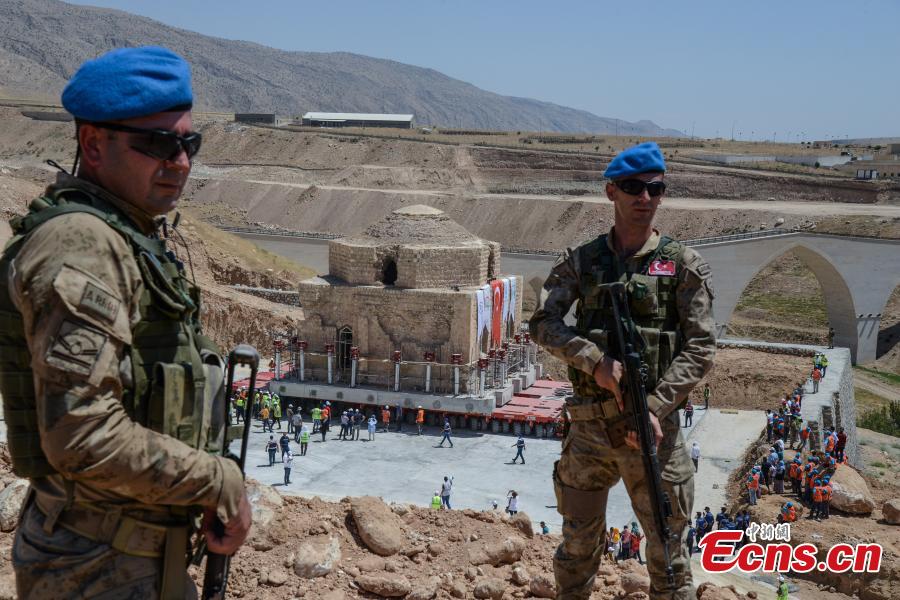 Turkish soldiers stand guard as the Artuklu Hamam, a centuries-old bath house weighing 1,600 tons, is loaded onto a wheeled platform and moved down a specially constructed road, on August 6, 2018, from the southeastern town of Hasankeyf to a new location to avoid being engulfed under floodwaters by a dam project. (Photo/Agencies)
