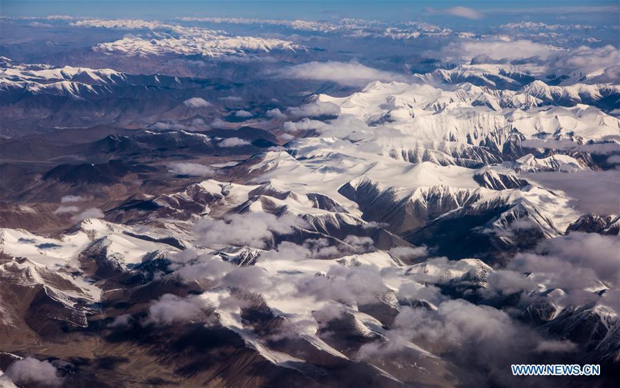 Aerial photo taken on May 15, 2018 shows the view of snow-covered Kunlun Mountains, northwest China\'s Xinjiang Uygur Autonomous Region. China\'s westernmost Xinjiang Uygur Autonomous Region welcomed a record high of 107 million tourists in 2017, up 32.4 percent year on year. In addition, tourists spent over 182 billion yuan (28.4 billion U.S. dollars) in Xinjiang last year, 30 percent more than in 2016. (Xinhua/Jiang Wenyao)