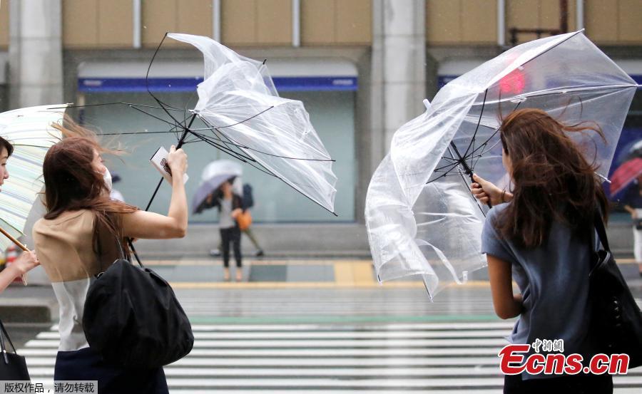 Passersby using umbrellas struggle against a heavy rain and wind as Typhoon Shanshan approaches Japan\'s mainland in Tokyo, Japan, Aug. 8, 2018. (Photo/Agencies)