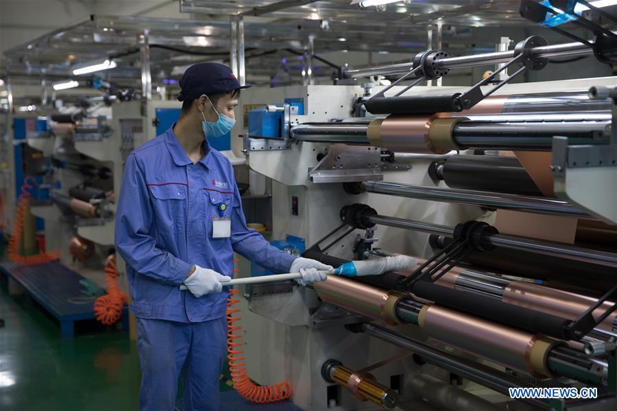 A staff member works on a production line of copper foil for making lithium battery at Huachuang New Material Co., Ltd in Tongling City, east China\'s Anhui Province, Aug. 8, 2018. Tongling government takes measures to improve ecological environment and develop green industry along the Yangtze River. (Xinhua/Jin Liwang)