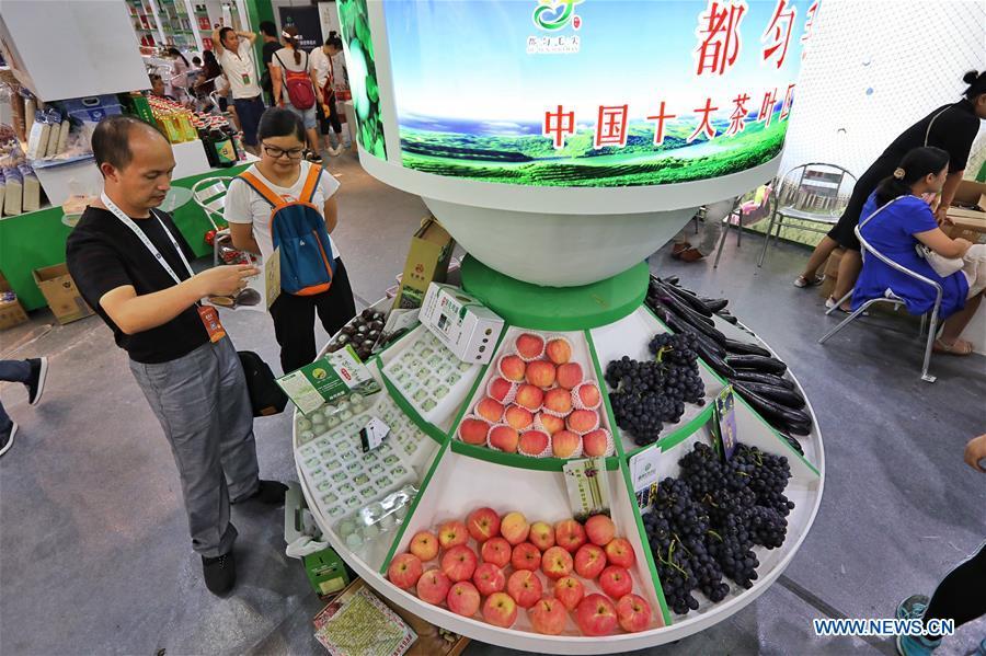 People visit a farmland products fair in Guiyang, capital of southwest China\'s Guizhou Province, Aug. 9, 2018. The five-day fair kicked off on Thursday. (Xinhua/Liu Xu)