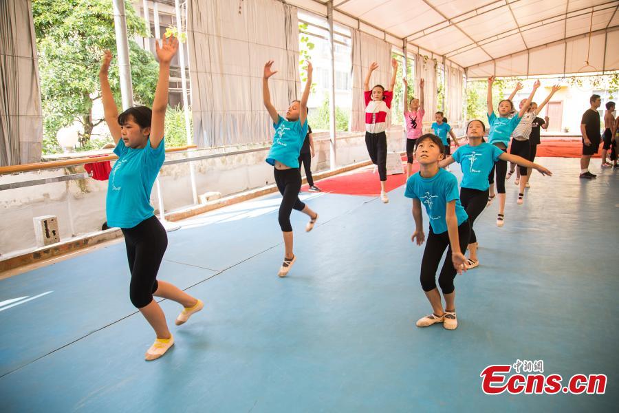Children acrobats train at a gym in Nanning, the capital of South China’s Guangxi Zhuang Autonomous Region, Aug. 9, 2018. Most of the children training with the acrobatics troupe led by Li Dewei are from the poverty-stricken Mashan County and they dream of one day improving the financial position of their families through their performances. (Photo: China News Service/Chen Guanyan)