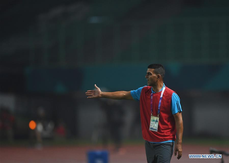 Ayman Sandouqa, head coach of Palestine, reacts during the Men\'s Football Group A match between Chinese Taipei and Palestine at the 18th Asian Games at Patriot Stadium in Bekasi, Indonesia, Aug. 10, 2018. (Xinhua/Jia Yuchen)