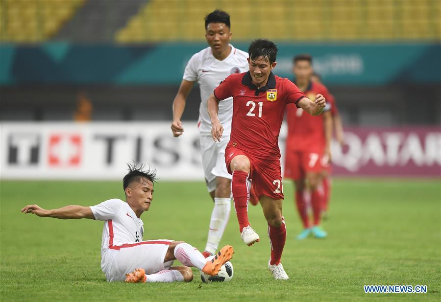 Yu Pui Hong (L) of Hong Kong of China vies with Bounmalay Tiny of Laos during the Men\'s Football Group A match between Hong Kong of China and Laos at the 18th Asian Games at Patriot Stadium in Bekasi, Indonesia, Aug. 10, 2018. (Xinhua/Jia Yuchen)