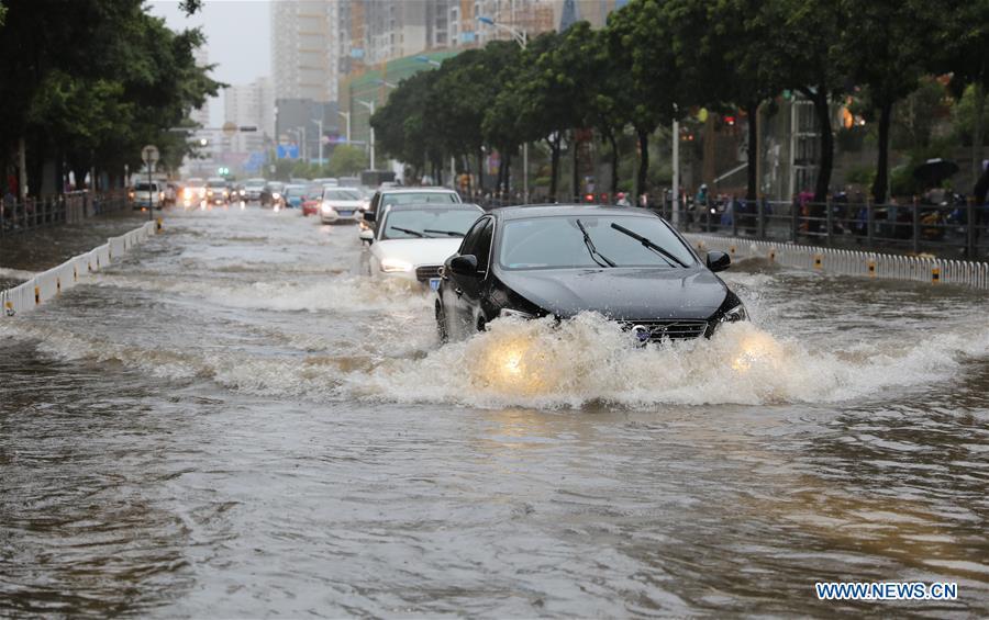 Cars run through the floodwater in Haikou, south China\'s Hainan Province, Aug. 10, 2018. Hainan was hit by heavy rainfalls under the influence of a tropical depression on Friday, which triggered a red alert for rainstorms in seven cities and counties, including Haikou. (Xinhua/Wang Junfeng)