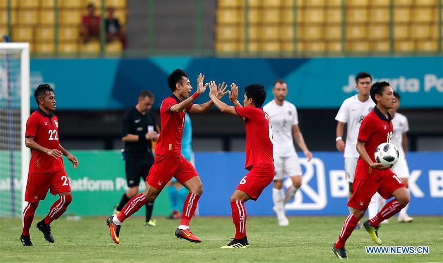 Natphasouk Soukchinda (front 2nd L) of Laos celebrates after scoring during the Men\'s Football Group A match between Hong Kong of China and Laos at the 18th Asian Games at Patriot Stadium in Bekasi, Indonesia, Aug. 10, 2018. Hong Kong of China won 3-1. (Xinhua/Wang Lili)