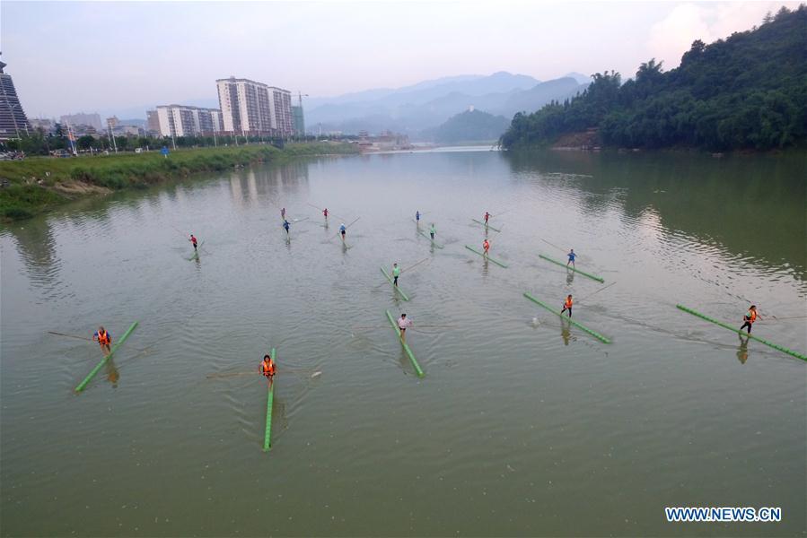 Middle school students practice single bamboo drifting on water in Rongjiang County, southwest China\'s Guizhou Province, Aug. 11, 2018. Single bamboo drifting originated in China\'s Guizhou and requires a person to stand or sit on a single piece of bamboo while performing graceful movements. (Xinhua/Wang Bingzhen)