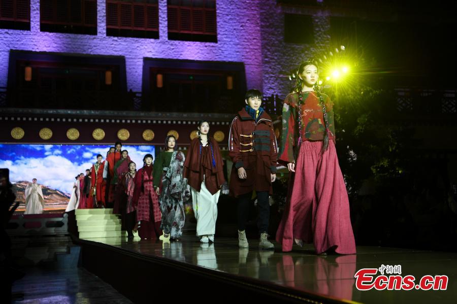 Models present outfits during a fashion show in Lhasa, Tibet Autonomous Region, Aug. 12, 2018. Models presented 84 designs including 26 traditional Tibetan costumes in the fashion show organized by Tibet Vocational Technical College and the Beijing Institute of Fashion Technology. (Photo/Xinhua)