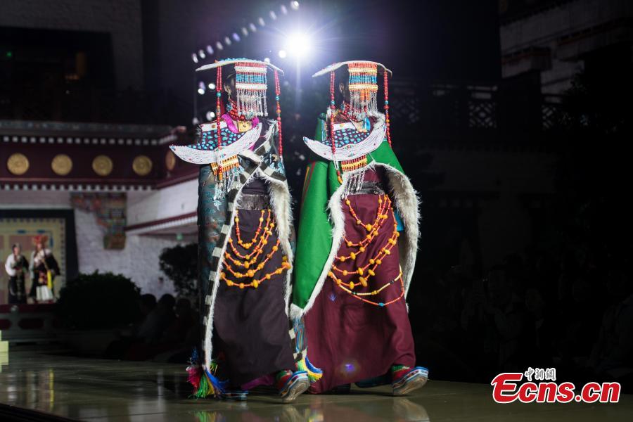 Models present outfits during a fashion show in Lhasa, Tibet Autonomous Region, Aug. 12, 2018. Models presented 84 designs including 26 traditional Tibetan costumes in the fashion show organized by Tibet Vocational Technical College and the Beijing Institute of Fashion Technology. (Photo/Xinhua)