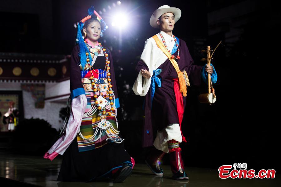 Models present outfits during a fashion show in Lhasa, Tibet Autonomous Region, Aug. 12, 2018. Models presented 84 designs including 26 traditional Tibetan costumes in the fashion show organized by Tibet Vocational Technical College and the Beijing Institute of Fashion Technology. (Photo/Xinhua)