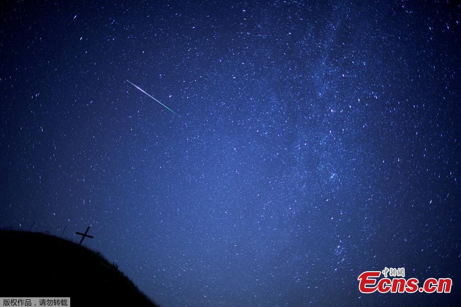 A meteor streaks past the Milky Way in the night sky above Leeberg hill during the Perseid meteor shower in Grossmugl, Austria, August 12, 2018. (Photo/Agencies)