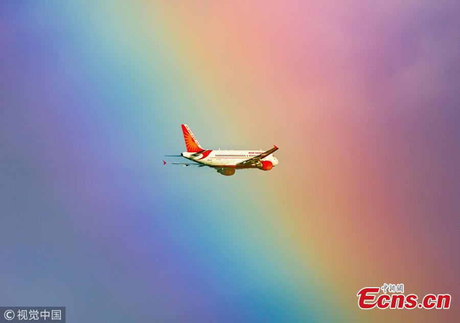 This stunning image shows a passenger plane flying straight into a rainbow. The jumbo jet breaks through the cloud and into the arc, which produces a kaleidoscope of colour. The moment was captured by photographer Tanay Das, shortly after the Indian Airlines flight took off from Netaji Subhas Chandra Bose International Airport in Kolkata, India. (Photo/VCG)