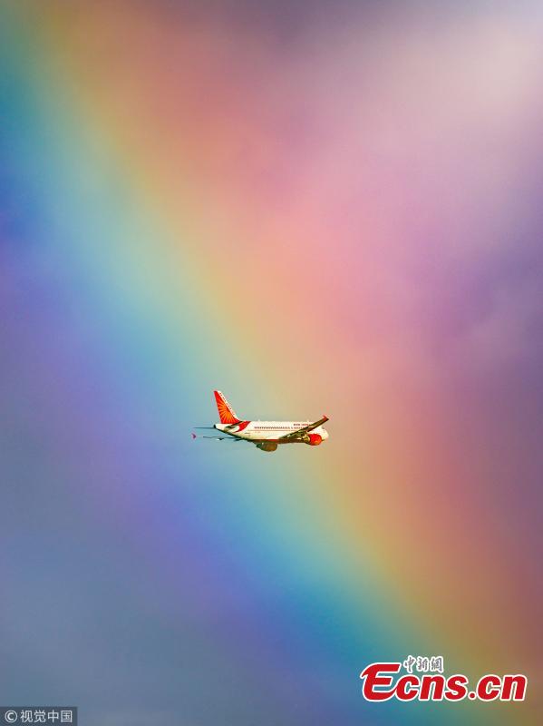 This stunning image shows a passenger plane flying straight into a rainbow. The jumbo jet breaks through the cloud and into the arc, which produces a kaleidoscope of colour. The moment was captured by photographer Tanay Das, shortly after the Indian Airlines flight took off from Netaji Subhas Chandra Bose International Airport in Kolkata, India. (Photo/VCG)