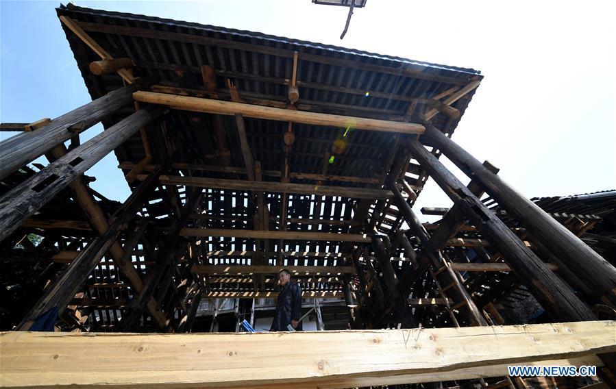 A villager walks in an old opera stage in reform in Zaidang, Qiandongnan of southwest China\'s Guizhou Province, Aug. 14, 2018. Zaidang, a village of Dong ethnic group, has encouraged its villagers to make use of idle resources to upgrade local infrastructure, in an aim to develop tourism industry and shake off poverty. (Xinhua/Wang Bingzhen)