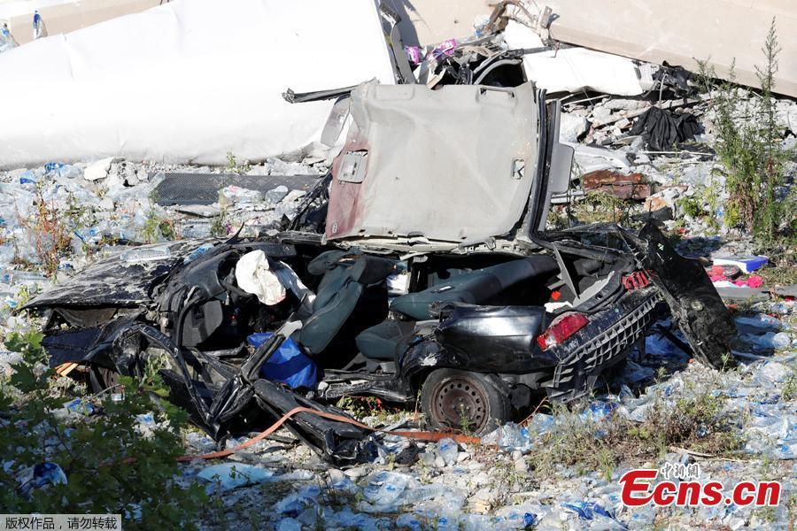 A crushed car is seen at the collapsed Morandi Bridge site in the port city of Genoa, Italy August 14, 2018. The bridge connects the highway A10 to the western part of the city, near a populous neighborhood called Sampierdarena. At least 26 people were killed in the accident. (Photo/Agencies)