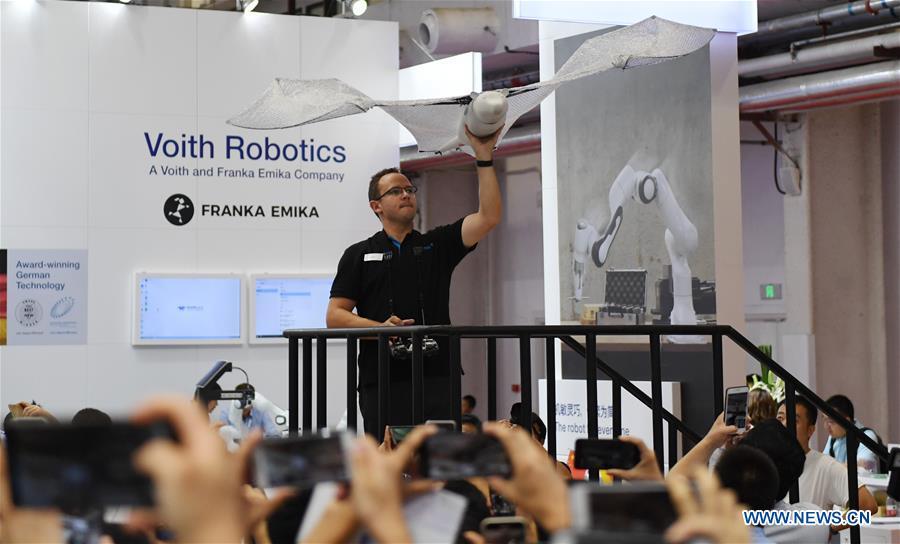 An exhibitor displays a bat-like bionic robot at World Robot Conference 2018 in Beijing, capital of China, Aug. 15, 2018. Kicking off on Wednesday, the Conference attracted contestants from 16 countries and regions to participate in the contest section. (Xinhua/Zhang Chenlin)