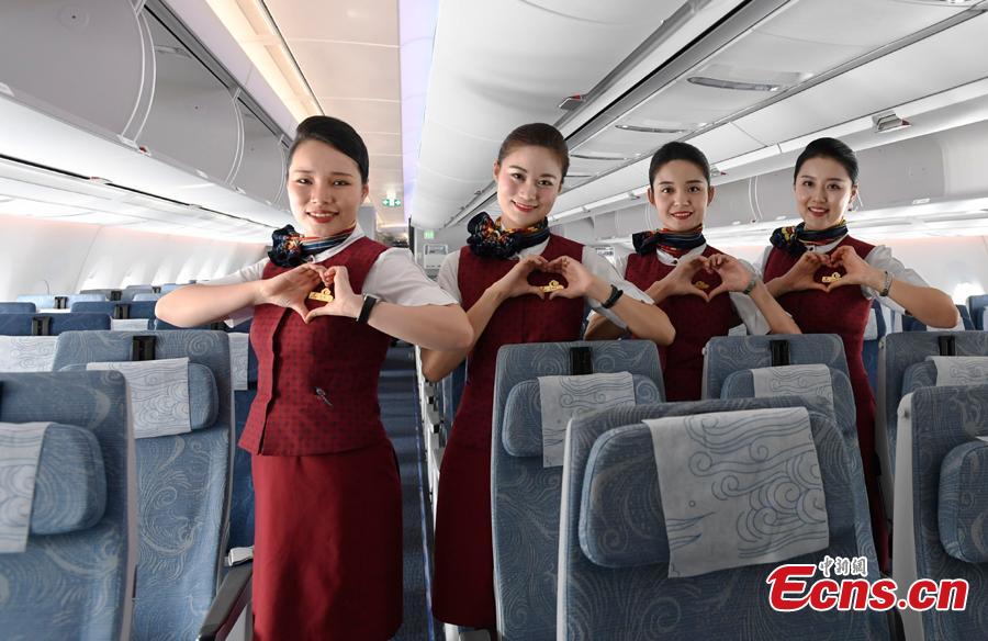 Stewardesses pose for a photo in Air China’s first A350-900 aircraft, in Chengdu City, Sichuan Province, Aug. 15, 2018. Air China has configured the widebody aircraft with three classes, offering a total of 312 seats. The business class cabin has 32 seats laid out in a 1-2-1 reverse herringbone pattern. The premium economy cabin has 24 seats and the economy cabin offers 256 seats. (Photo: China News Service/An Yuan)