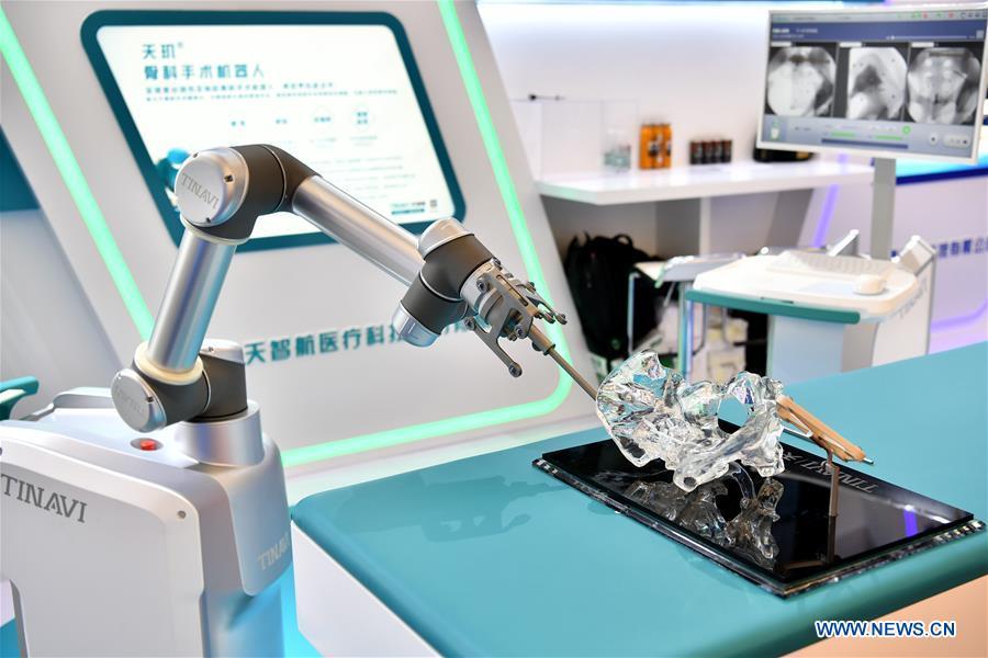 Photo taken on Aug. 15, 2018 shows a robot performing orthopedic surgery at World Robot Conference 2018 in Beijing, capital of China. Kicking off on Wednesday, the conference attracted more than 160 domestic and international corporations exhibiting their cutting-edge products in the robotics industry. (Xinhua/Li Xin)