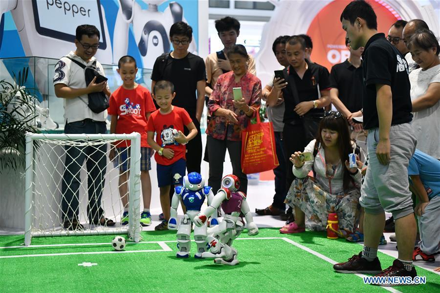 Photo taken on Aug. 15, 2018 shows two robots playing football at World Robot Conference 2018 in Beijing, capital of China. Kicking off on Wednesday, the conference attracted more than 160 domestic and international corporations exhibiting their cutting-edge products in the robotics industry. (Xinhua/Li Xin)