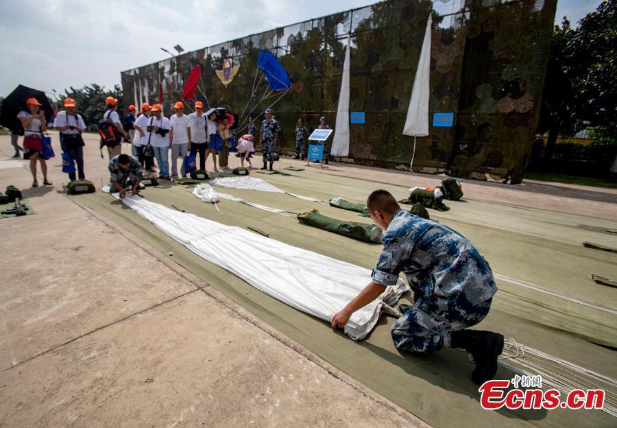 Soldiers arrange parachuting equipment during a military open day in Wuhan City, Central China’s Hubei Province, Aug. 15, 2018. The event, supervised by the National Defense Education Office, attracted representatives of various military units as well as some 3,000 visitors. Since 2012, Wuhan has organized events allowing hundreds of thousands of people to visit barracks as part of national defense education. (Photo: China News Service/Zhang Chang)
