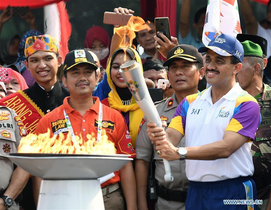 Mayor of East Jakarta M. Anwar (R Front) participates in the Torch Relay in Jakarta, Indonesia, Aug. 15, 2018. The 2018 Asian Games will kick off here on Aug. 18. (Xinhua/Li He)