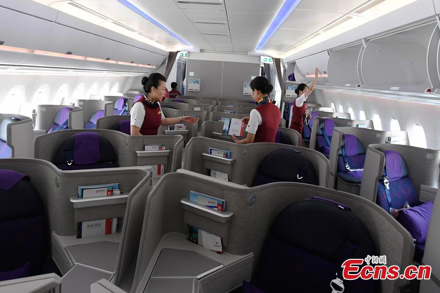 Stewardesses make security check in Air China’s first A350-900 aircraft before it flies on the Beijing-Chengdu route, Aug. 15, 2018. Air China has configured the widebody aircraft with three classes, offering a total of 312 seats. The business class cabin has 32 seats laid out in a 1-2-1 reverse herringbone pattern. The premium economy cabin has 24 seats and the economy cabin offers 256 seats. (Photo: China News Service/An Yuan)