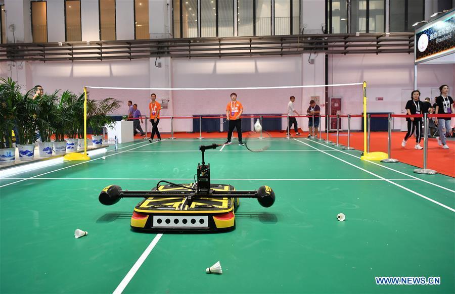 A robot plays badminton with an exhibitor at World Robot Conference 2018 in Beijing, capital of China, Aug. 15, 2018. Kicking off on Wednesday, the conference attracted more than 160 domestic and international corporations exhibiting their cutting-edge products in the robotics industry. (Xinhua/Li Xin)