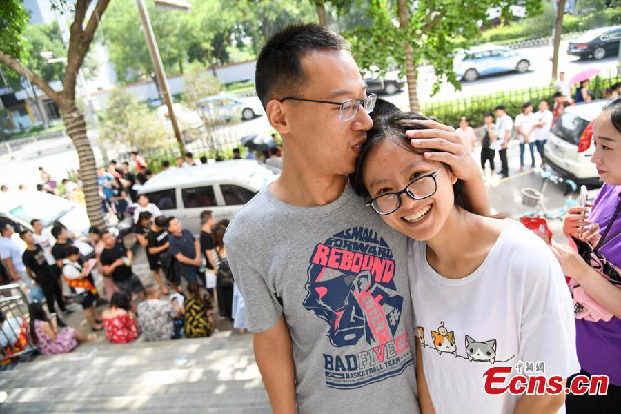 A couple poses for a photo as they complete their marriage registration at the civil affairs department in Taiyuan City, Shanxi Province, Aug. 17, 2018 on the Qixi Festival, known as China’s Valentine\'s Day. Falling on the seventh day of the seventh lunar month on the Chinese calendar, the festival celebrates the annual meeting of a cowherd and weaver girl in Chinese mythology. Some reportedly got up at 5 am to register on a day considered auspicious. (Photo: China News Service/Wu Junjie)