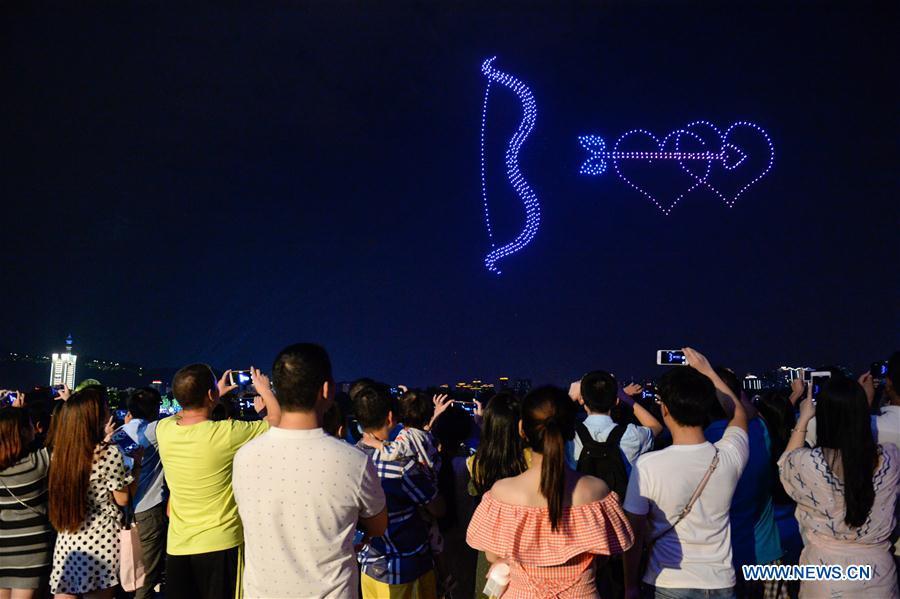 People view drones performance at the Orange Isle scenic area in Changsha, central China\'s Hunan Province, Aug. 16, 2018. Groups of drones performed a light show here to greet the Qixi festival, or Chinese Valentine\'s Day, which falls on Aug. 17 this year. (Xinhua/Zhang Xiaoyu)