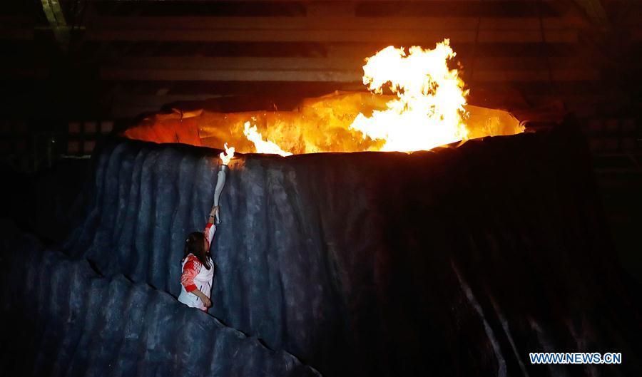Torchbearer Susi Susanti of Indonesia lights up fire at the opening ceremony of the 18th Asian Games at Gelora Bung Karno (GBK) Main Stadium in Jakarta, Indonesia, Aug. 18, 2018.(Xinhua/Wang Lili)