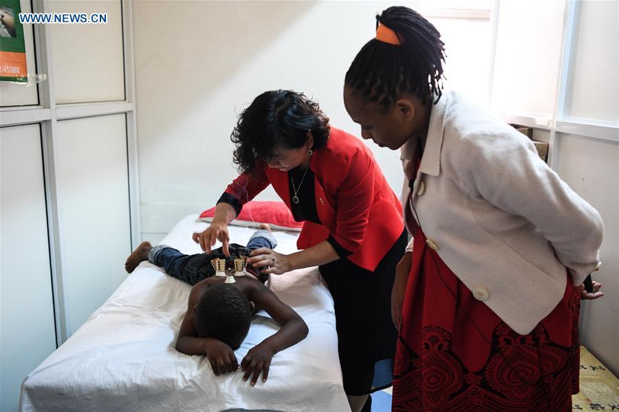 Pan Lianxue does moxibustion treatment for a local patient at her clinic in Nairobi, Kenya, Aug. 17, 2018. Pan Lianxue and her husband Luo Zhanliang, both Chinese doctors in traditional Chinese medicine, have been operated a clinic in Nairobi for over 20 years attracting more and more African patients. China issued the first Medical Workers\' Day on Aug. 19.(Xinhua/Li Yan)