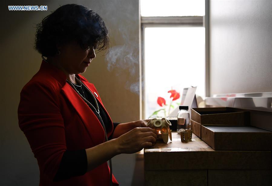 Pan Lianxue prepares to practise moxibustion treatment for a local patient at her clinic in Nairobi, Kenya, Aug. 17, 2018. Pan Lianxue and her husband Luo Zhanliang, both Chinese doctors in traditional Chinese medicine, have been operated a clinic in Nairobi for over 20 years attracting more and more African patients. China issued the first Medical Workers\' Day on Aug. 19.(Xinhua/Li Yan)
