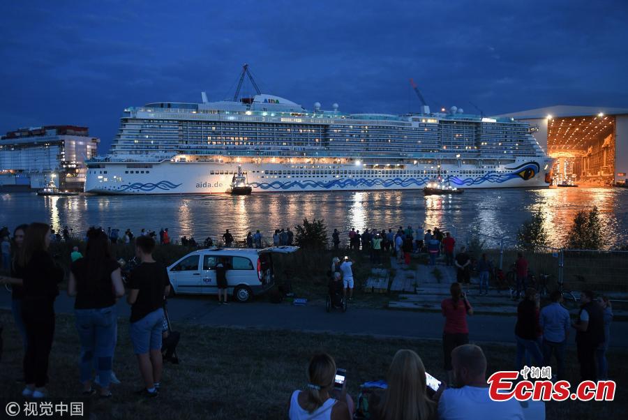 A tug boat pulls out the \'AIDAnova\' cruise ship from the Meyer Werft shipyards on August 21, 2018 in Papenburg, Germany. The newly-completed 184,000-tonne ship, which is 337 meters long and can accommodate 6,600 passengers, cast and crew. AIDAnova is the World\'s first liquefied natural gas (LNG)-Powered Cruise Ship. (Photo/Agencies)