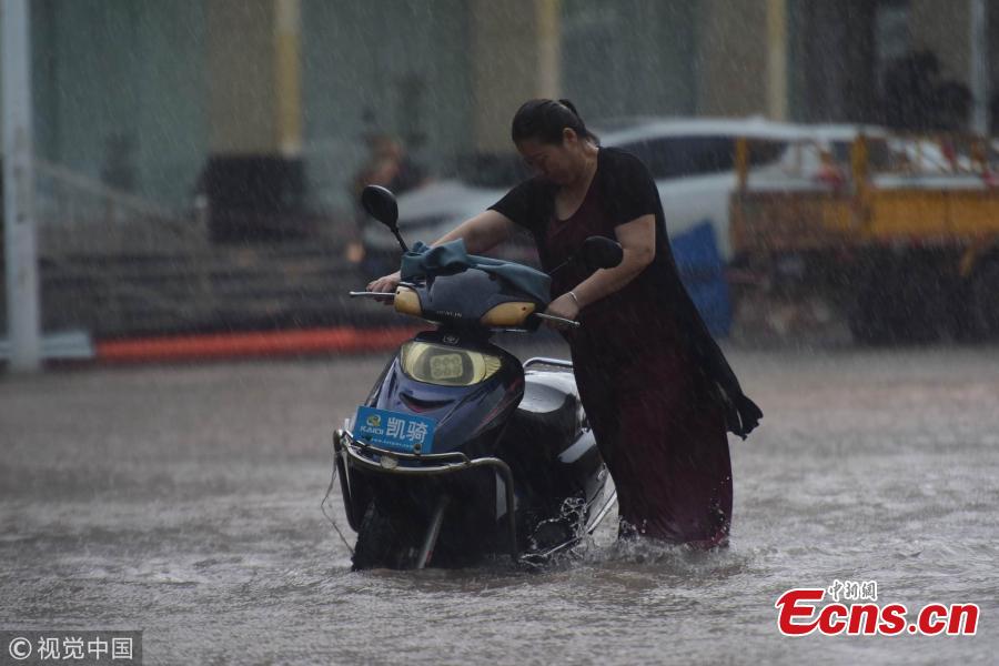 A street floods after a rainstorm in Qionghai City, Hainan Province on Aug. 22, 2018. The local weather bureau issued a warning against thunderstorm and strong winds with it. (Photo/VCG)
