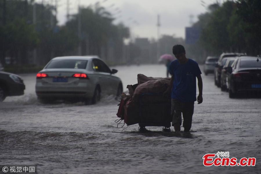 A street floods after a rainstorm in Qionghai City, Hainan Province on Aug. 22, 2018. The local weather bureau issued a warning against thunderstorm and strong winds with it. (Photo/VCG)