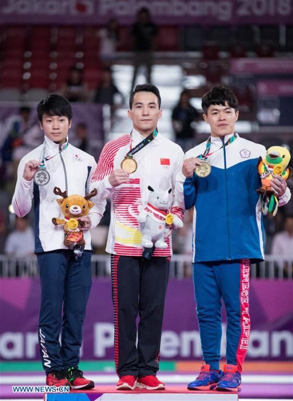 Deng Shudi (C) of China, Shogo Nonomura (L) of Japan and Chen Chih-Yu of Chinese Taipei pose for photo during the awarding ceremony for the Artistic Gymnastics Men\'s Rings Final at the Asian Games 2018 in Jakarta, Indonesia on Aug. 23, 2018. (Xinhua/Zhu Wei)