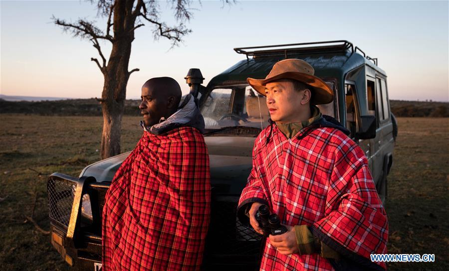 Chinese wildlife conservationist Zhuo Qiang and a local warden check the Ol Kinyei conservancy in Maasai Mara, Kenya, July 7, 2018. The founder and Chairman of Mara Conservation Fund (MCF) Zhuo Qiang, a 45-year-old Chinese, has pioneered outstanding wildlife conservation projects in the world famous Maasai Mara ecosystem. Ol Kinyei is among the conservancies benefiting from his activities. Around it, he has built three lion proof boas preventing the wildlife conflict with the adjacent communities. He was officially adopted as a son of the Maasai\'s Ol Kinyei conservation group in 2015, owing to his unwavering friendship with the pastoralists. Zhuo\'s anti-poaching drives in the East African nation expresses the increasing collaboration between Kenyan and China in ending the killing of rhinos, elephants and lions. (Xinhua/Lyu Shuai)