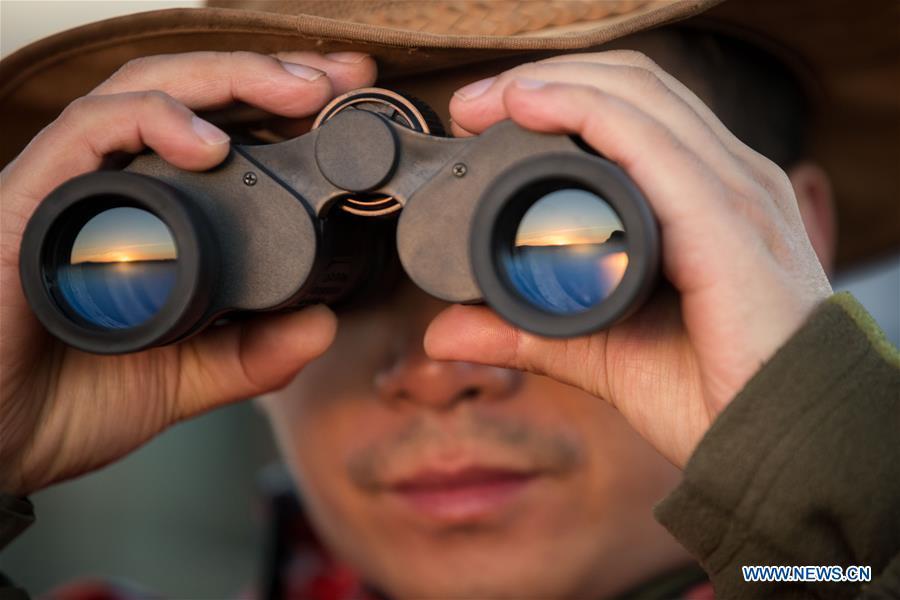 Chinese wildlife conservationist Zhuo Qiang checks the Ol Kinyei conservancy in Maasai Mara, Kenya, July 7, 2018. The founder and Chairman of Mara Conservation Fund (MCF) Zhuo Qiang, a 45-year-old Chinese, has pioneered outstanding wildlife conservation projects in the world famous Maasai Mara ecosystem. Ol Kinyei is among the conservancies benefiting from his activities. Around it, he has built three lion proof boas preventing the wildlife conflict with the adjacent communities. He was officially adopted as a son of the Maasai\'s Ol Kinyei conservation group in 2015, owing to his unwavering friendship with the pastoralists. Zhuo\'s anti-poaching drives in the East African nation expresses the increasing collaboration between Kenyan and China in ending the killing of rhinos, elephants and lions. (Xinhua/Lyu Shuai)