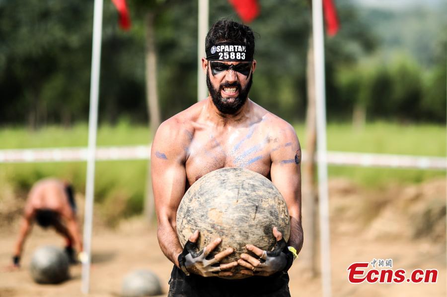 A participant competes in the 2018 Beijing Spartan Trifecta Weekend in Beijing, Aug. 26, 2018. More than 15,000 contestants participated in the obstacle course race that included three events of differing difficulty levels. (Photo: China News Service/Fu Tian)