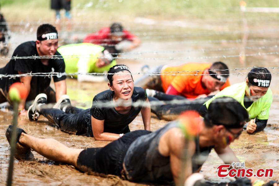 Participants compete in the 2018 Beijing Spartan Trifecta Weekend in Beijing, Aug. 26, 2018. More than 15,000 contestants participated in the obstacle course race that included three events of differing difficulty levels. (Photo: China News Service/Fu Tian)