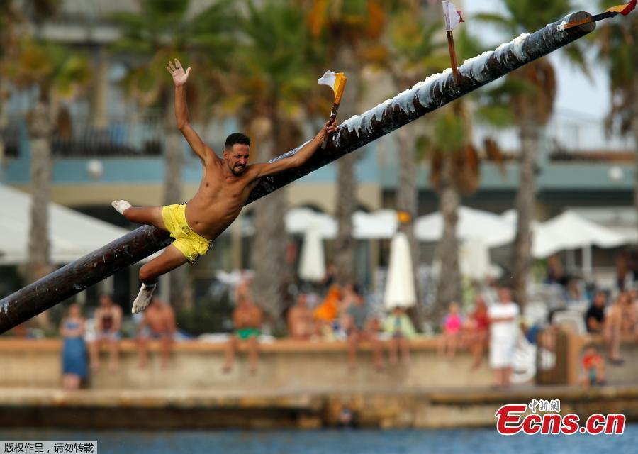 A competitor grabs the final flag as he slips off the \