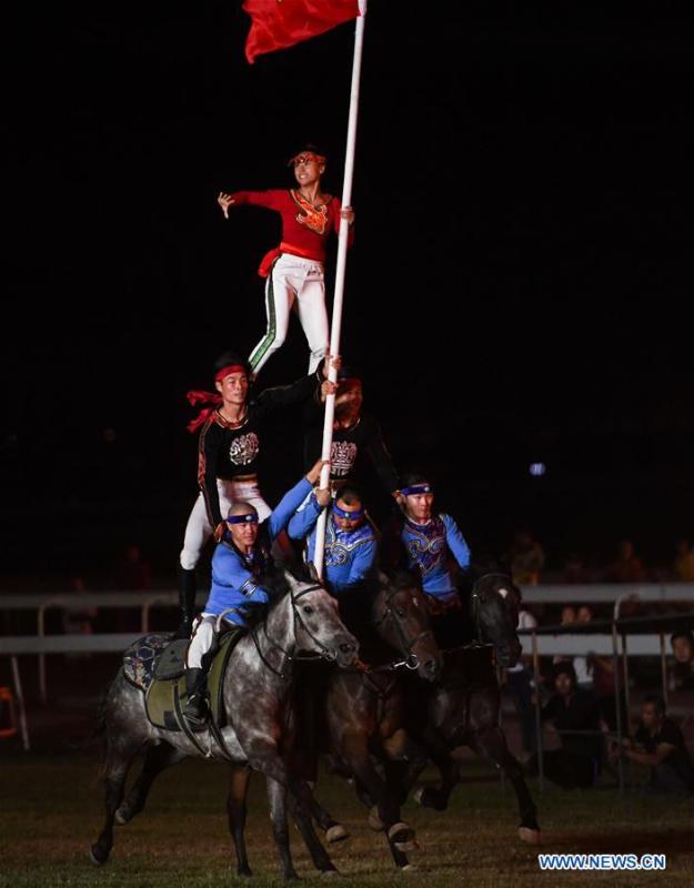 Performers present horse-riding skills during the opening ceremony of a horse-themed art week in Hohhot, capital of north China\'s Inner Mongolia Autonomous Region, Aug. 27, 2018. Kicked off here on Monday, the art week will include art performances, beer and food festival, and equestrian performances. (Xinhua/Peng Yuan)
