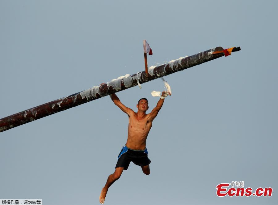 A competitor grabs the final flag as he slips off the \