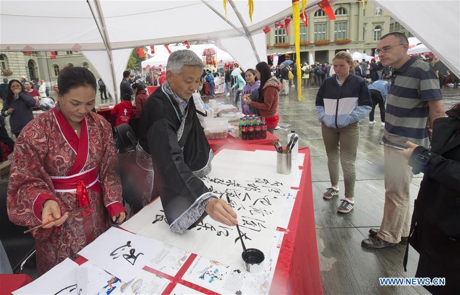 People write Chinese calligraphy during the \