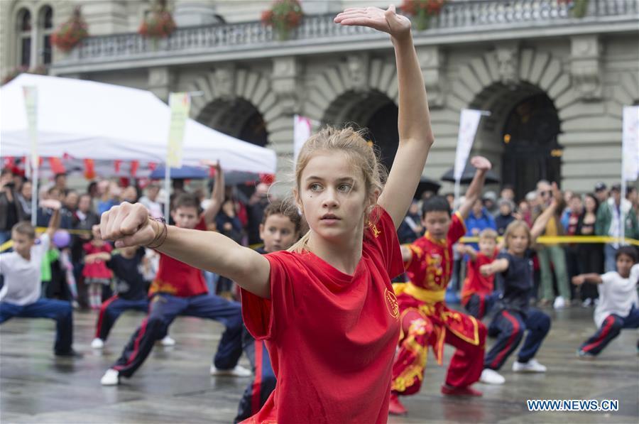 Local teenagers perform Chinese martial arts during the \