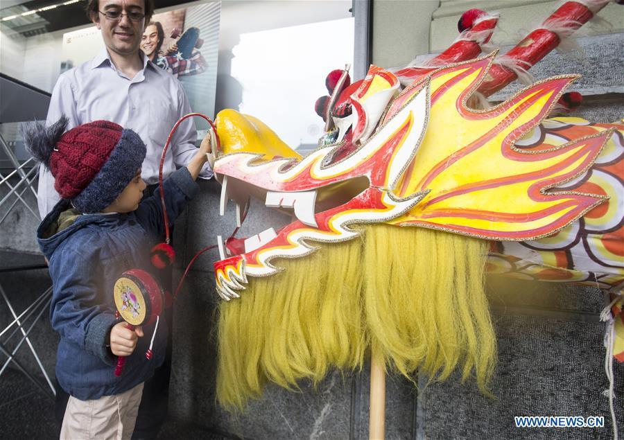 A child touches a dragon head during the \