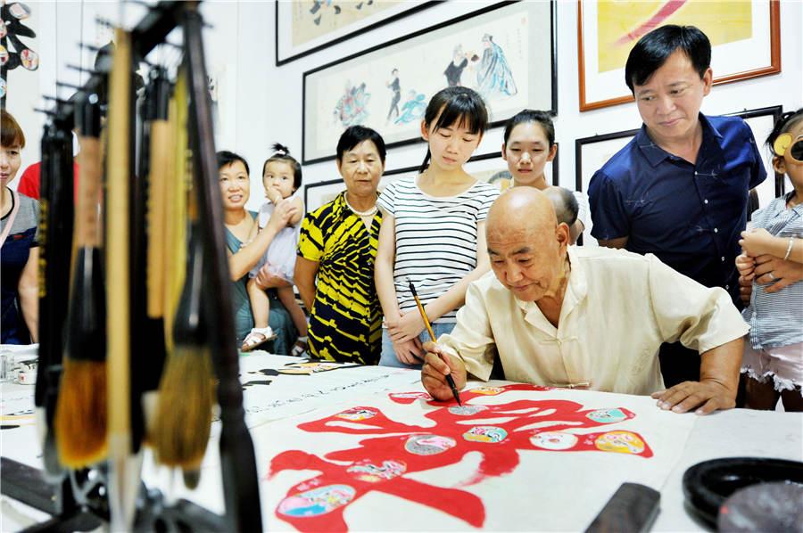 Zhao Xichun works on Peking Opera mask artwork in his workshop in Shaorao city, Jiangxi Province on Sept. 2, 2018. (Photo/Asianewsphoto)